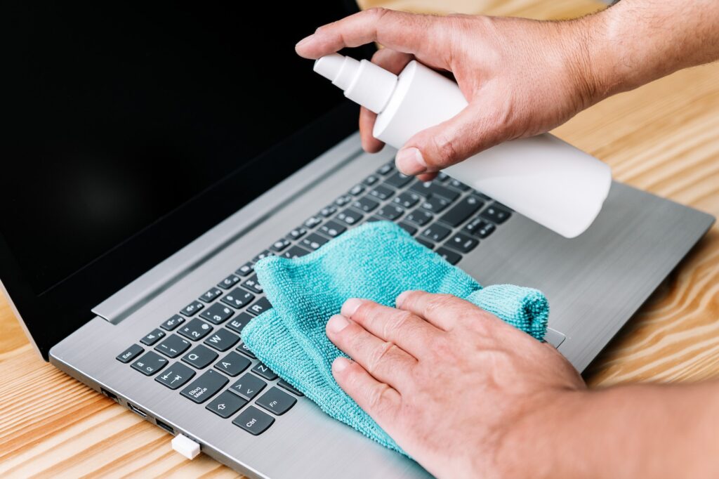 hand disinfecting computer with sanitizing spray